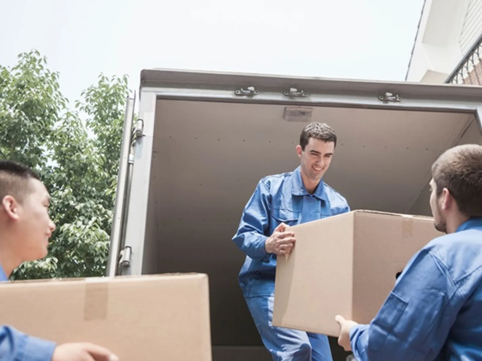 A person surrounded by moving boxes using their phone to search for local moving companies — representing the high-intent audience that LeadGulls PPC campaigns reach for movers